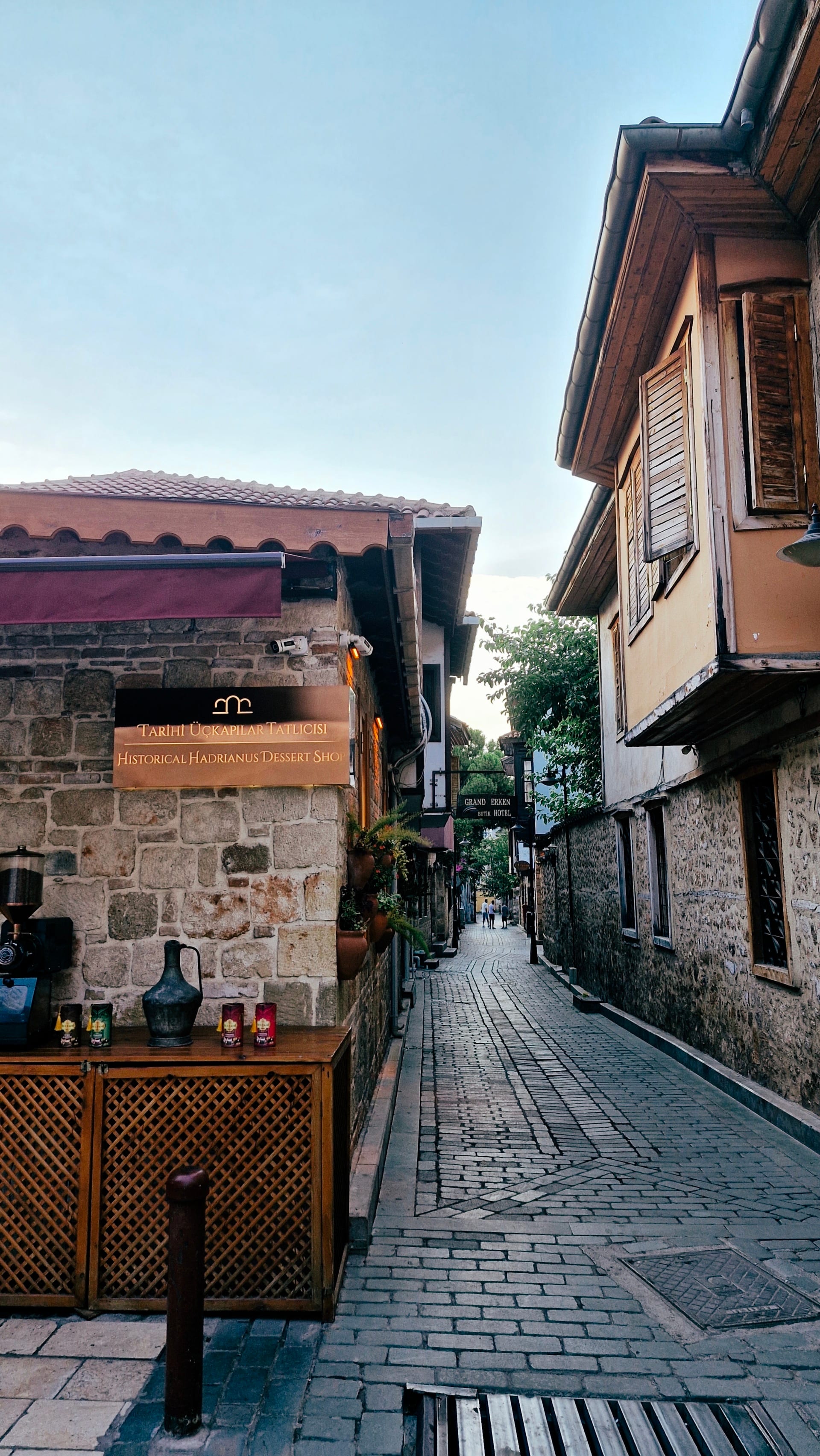 A narrow cobbled lane passes stone walls and projecting wooden windows.